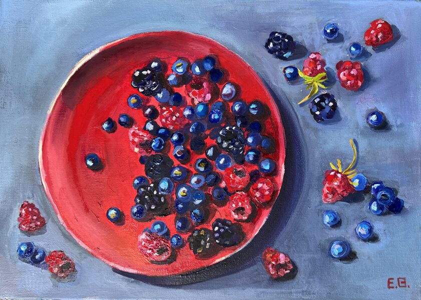 Berries on red kitchen plate